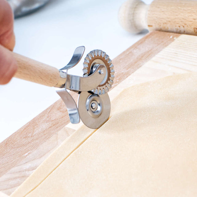 straight pastry cutter cutting pasta